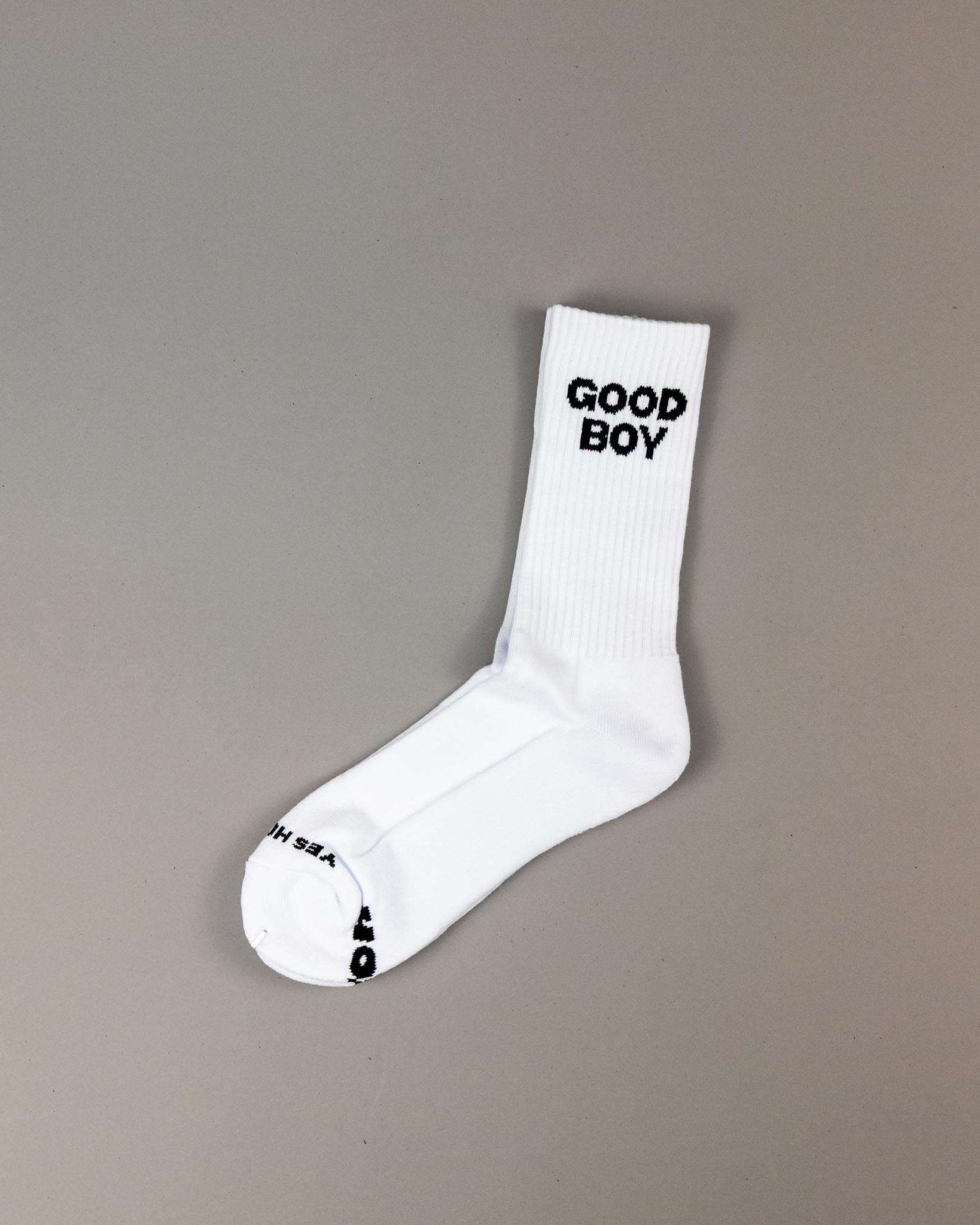 White sock with 'GOOD BOY' text on a gray background