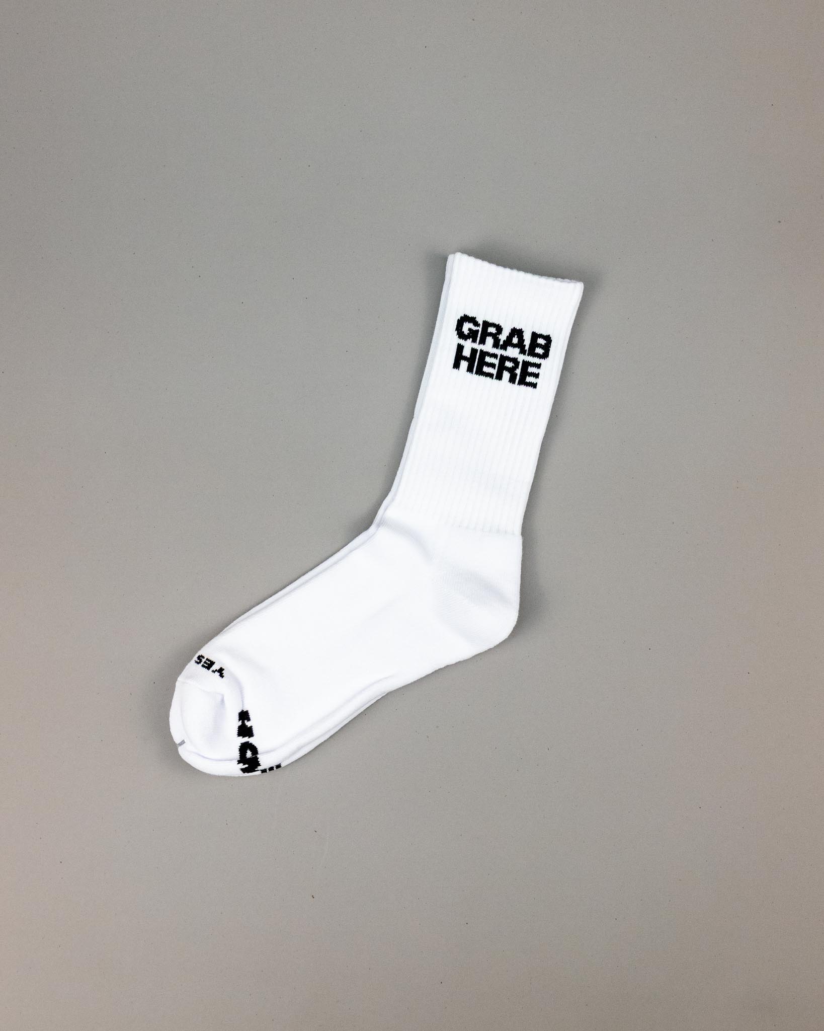 White sock with 'GRAB HERE' text on a gray background