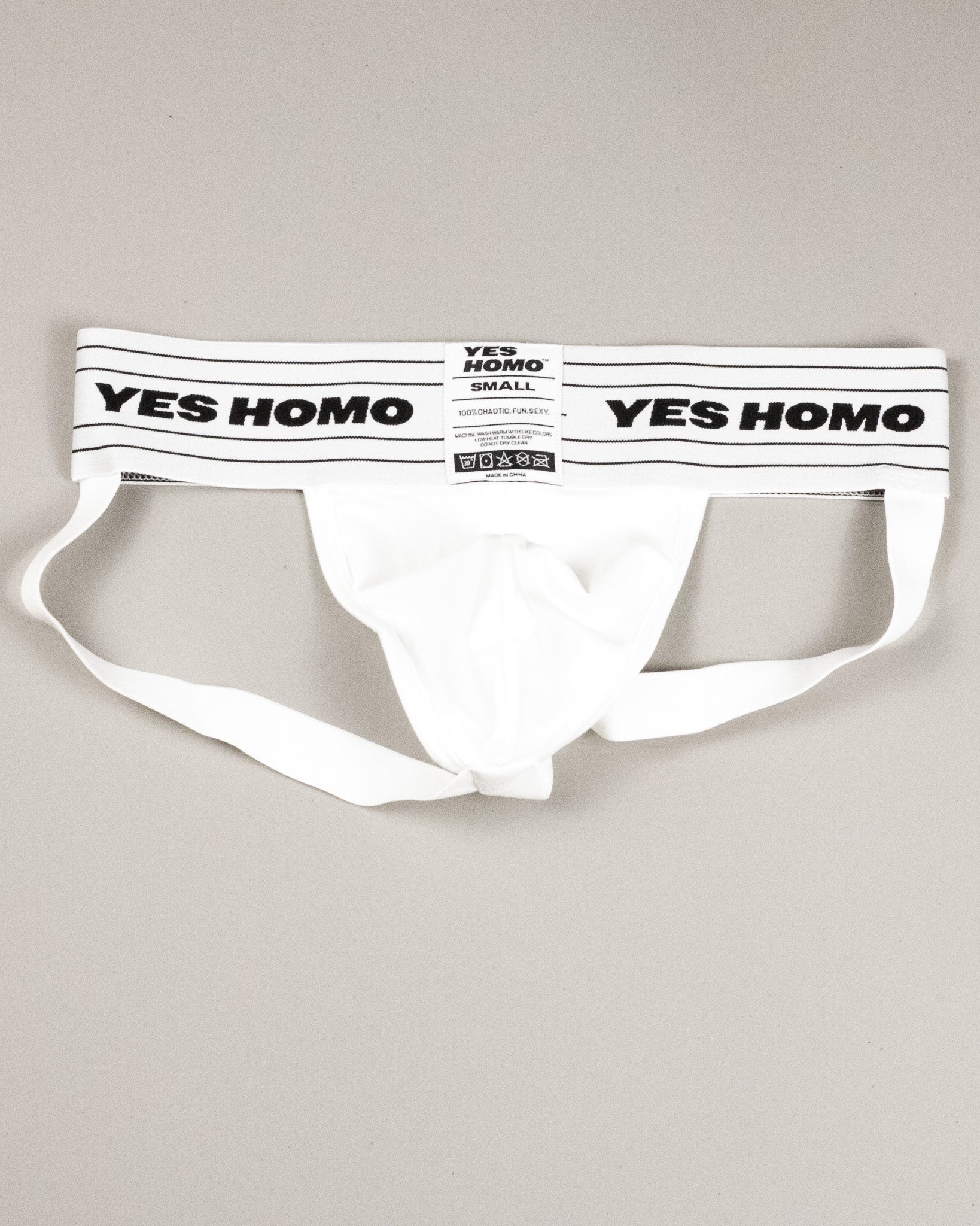 White men's underwear with 'YES HOMO' label on a light gray background