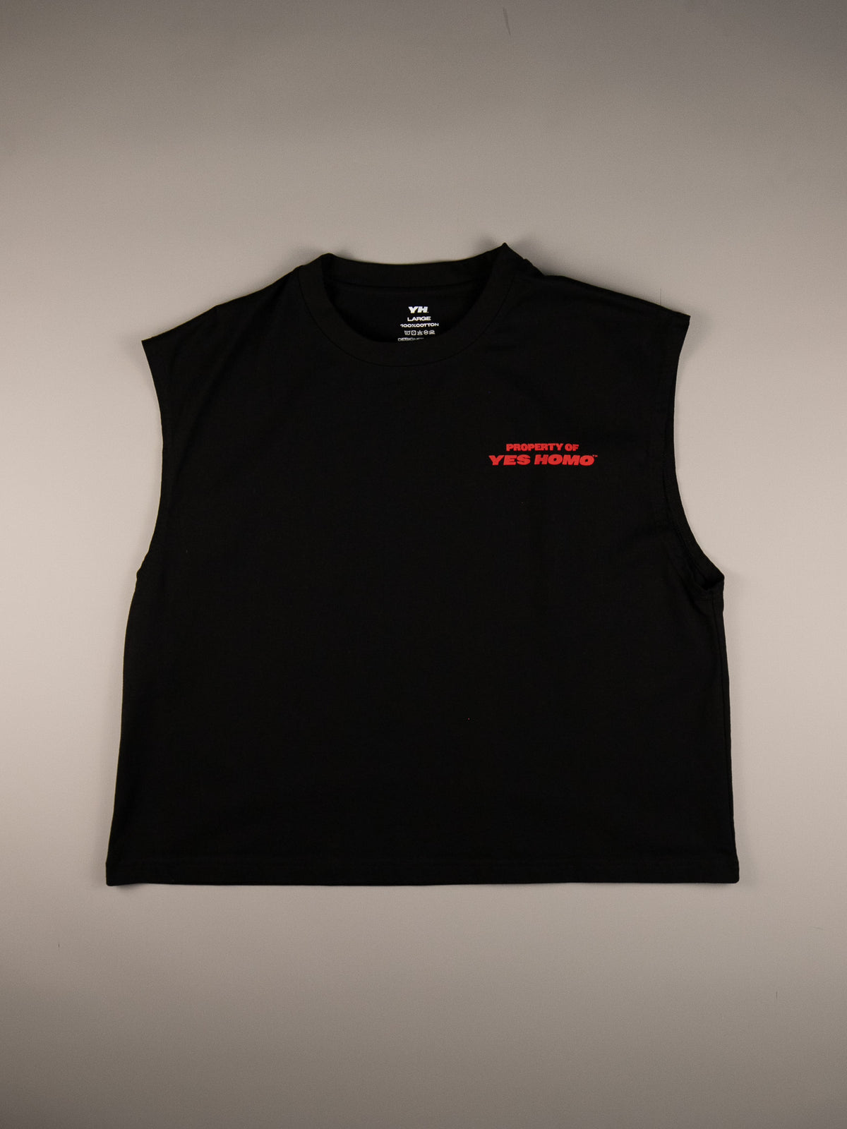 A black sleeveless crop top with a small red 'PROPERTY OF YES MOM' graphic on the left chest, laid flat against a neutral gray background.
